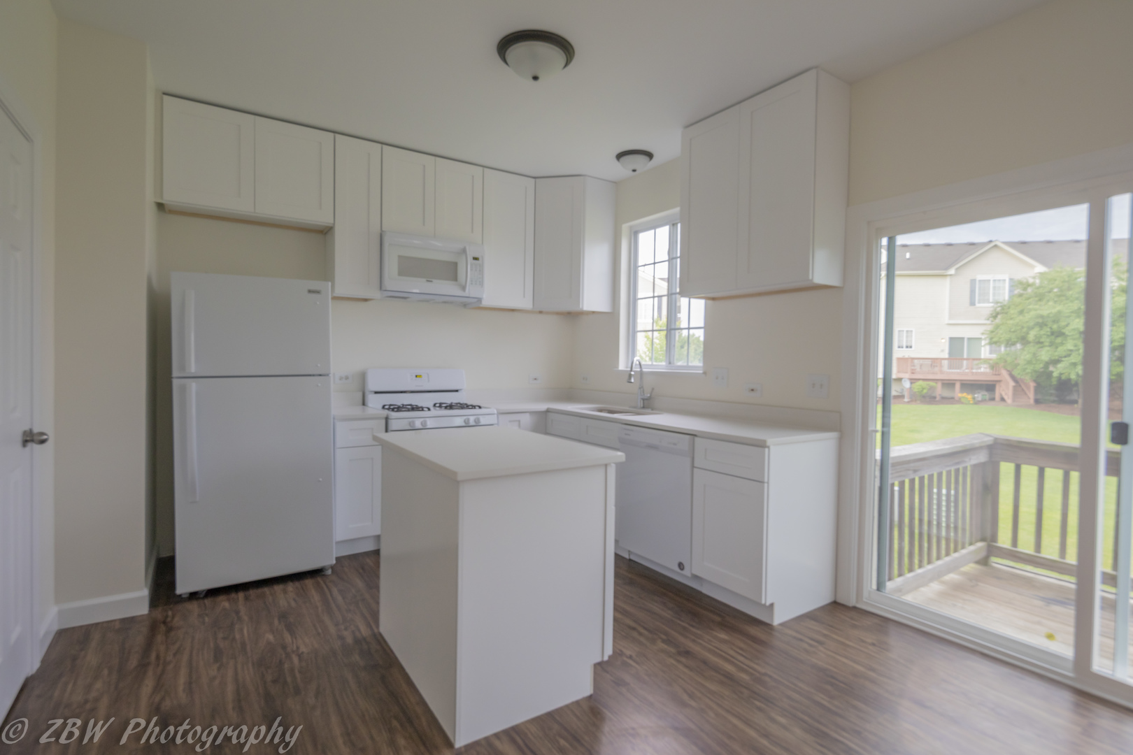 1906 Indian Hill Lane, Unit 1906 Aurora, IL 60503 - Photo 3 of 13 a kitchen with white cabinets and wooden floor