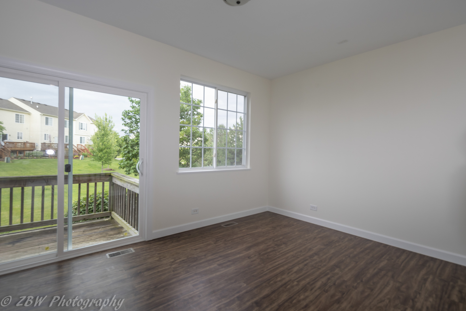 1906 Indian Hill Lane, Unit 1906 Aurora, IL 60503 - Photo 4 of 13 an empty room with wooden floor and windows