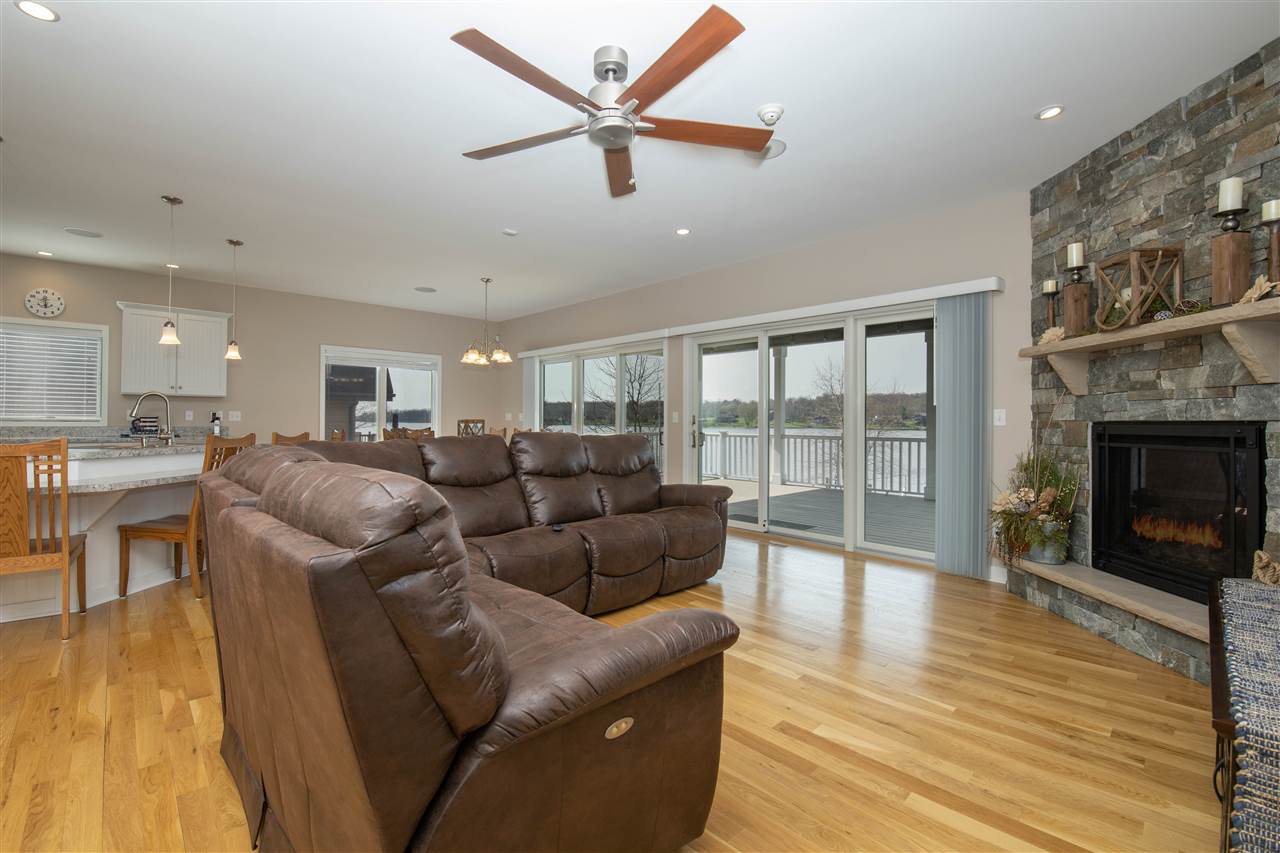 873 Breckenboro Road Davis, IL 61019 - Photo 11 of 41 a living room with furniture a fireplace and a floor to ceiling window