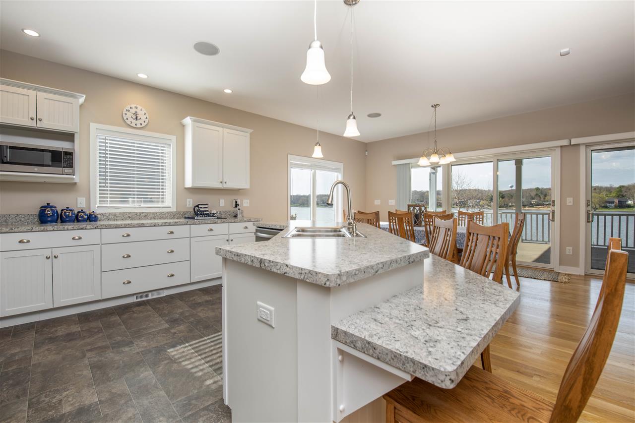 873 Breckenboro Road Davis, IL 61019 - Photo 12 of 41 a kitchen with stainless steel appliances granite countertop a sink stove and wooden floor