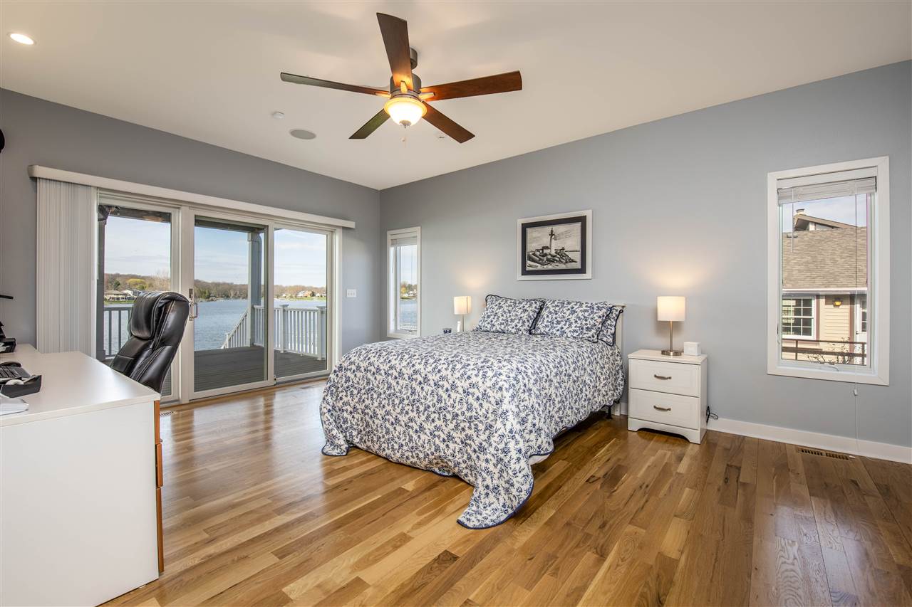 873 Breckenboro Road Davis, IL 61019 - Photo 15 of 41 a bedroom with a large bed a flat tv screen and a dresser