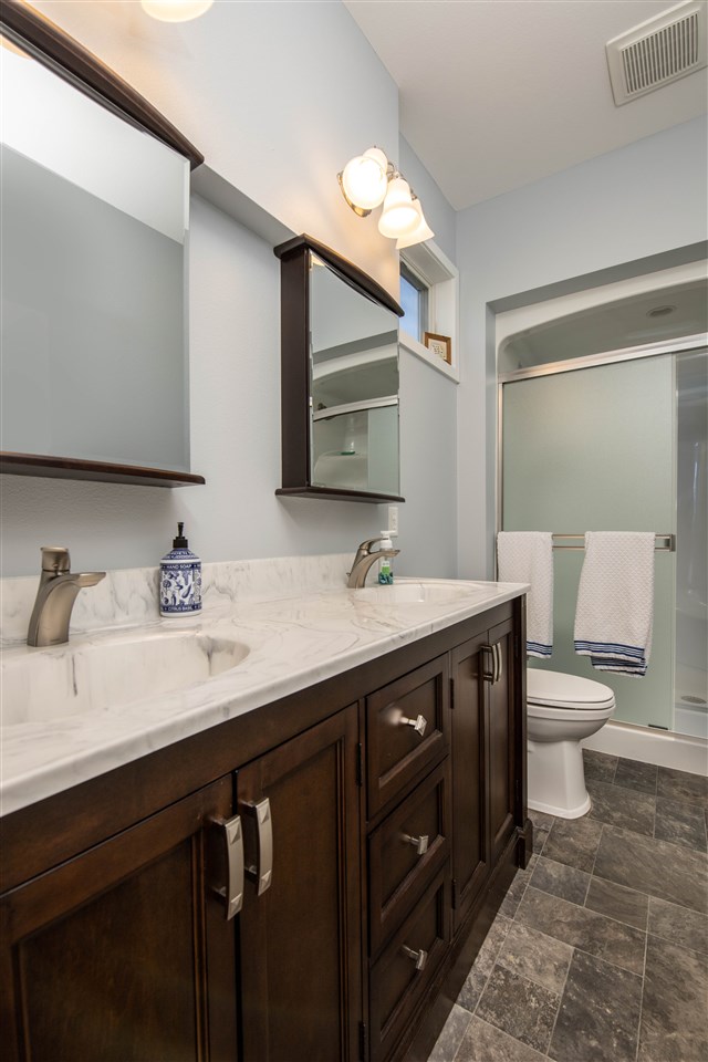 873 Breckenboro Road Davis, IL 61019 - Photo 18 of 41 a spacious bathroom with a double vanity sink and a mirror