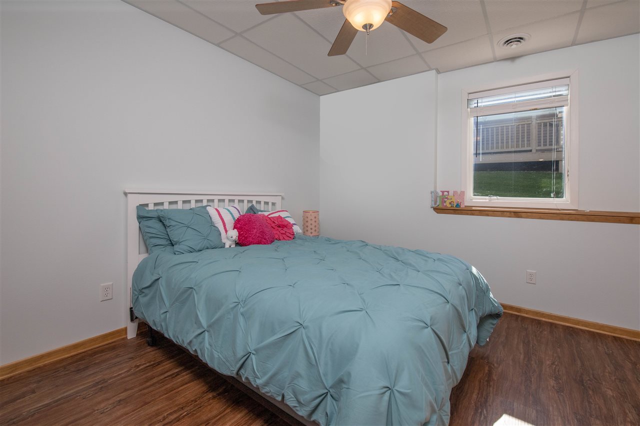 873 Breckenboro Road Davis, IL 61019 - Photo 28 of 41 a bedroom with a bed and a chandelier