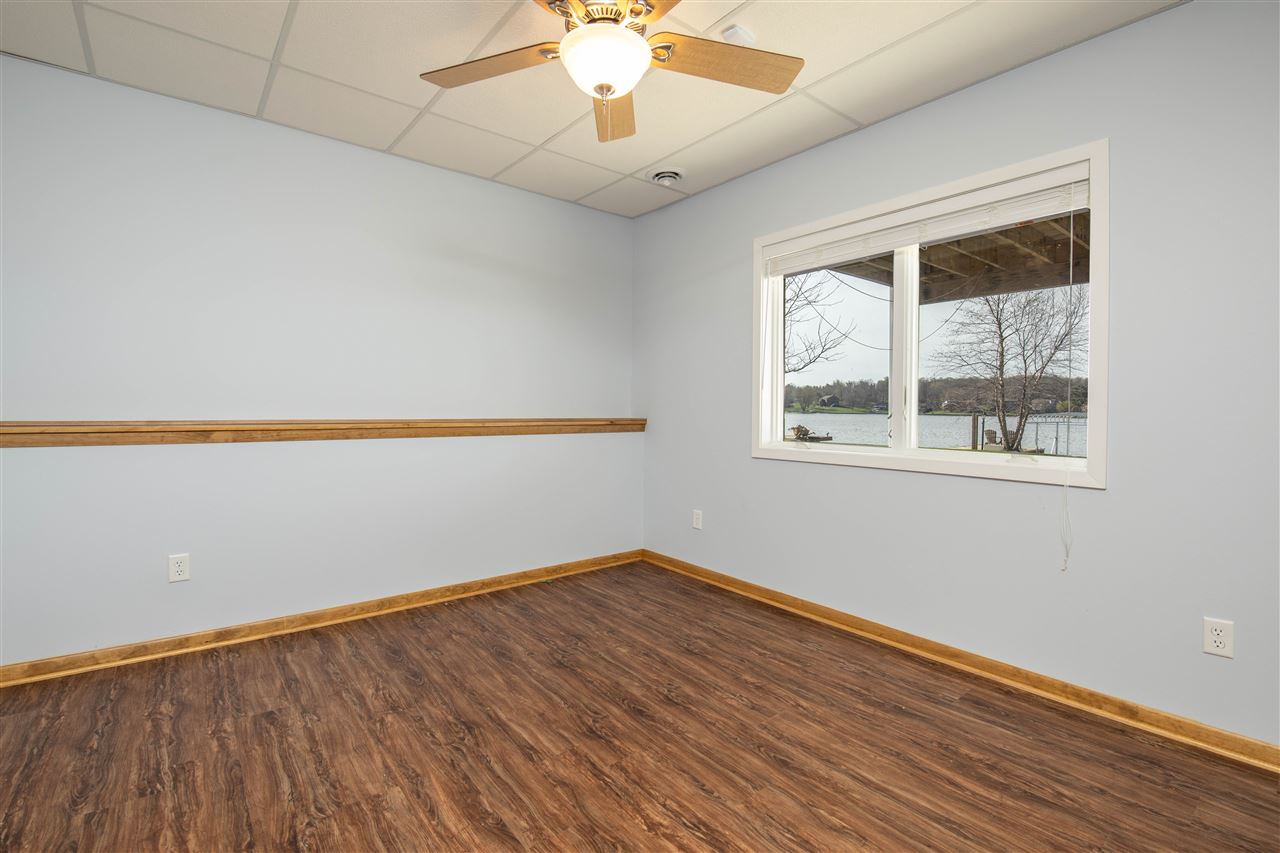 873 Breckenboro Road Davis, IL 61019 - Photo 30 of 41 an empty room with a window and a chandelier fan