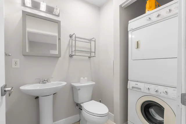 a bathroom with a sink toilet and a mirror