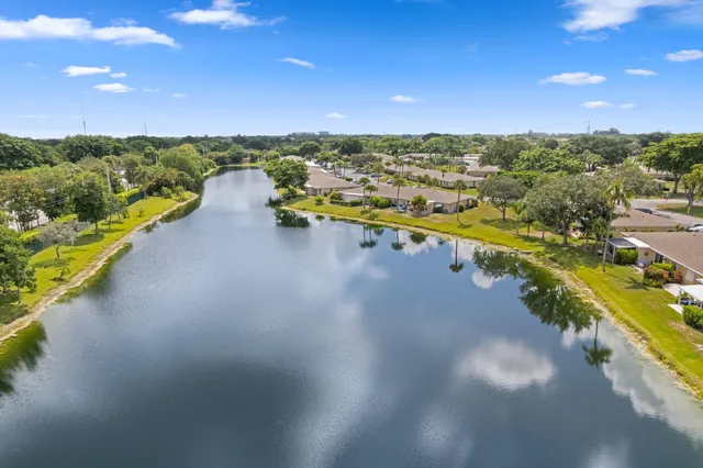an aerial view of residential houses with outdoor space and river