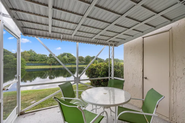 a view of a chair and tables in the patio