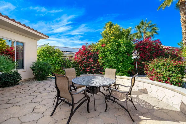 a view of a chairs and table in the patio