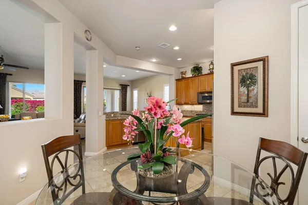 a dining room with furniture and flowers