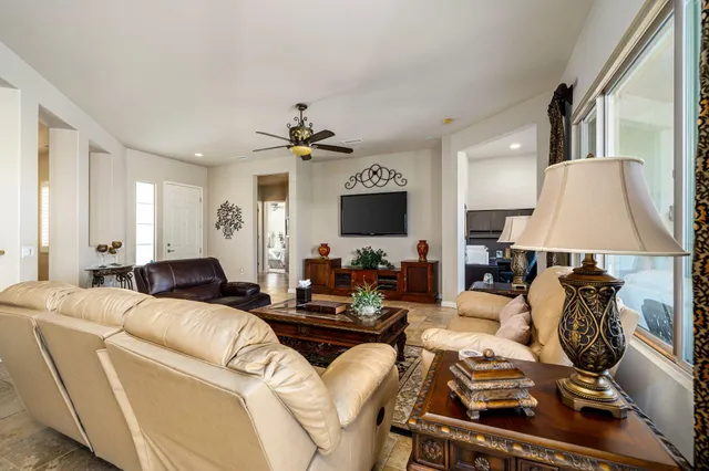 a living room with furniture a lamp and a flat screen tv