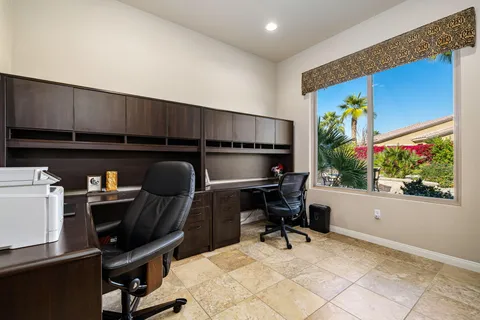 a work room with furniture and a potted plant