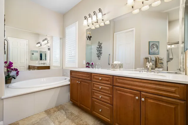 a bathroom with a tub sink and mirror