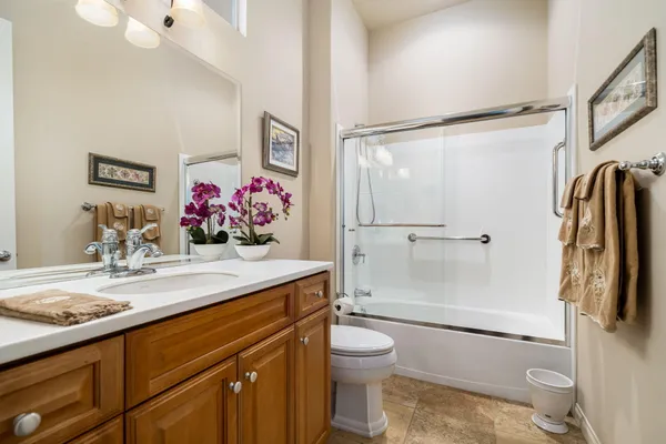 a bathroom with a sink toilet vanity and shower