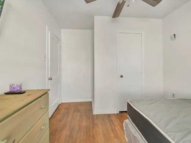 a view of storage and utility room with wooden floor