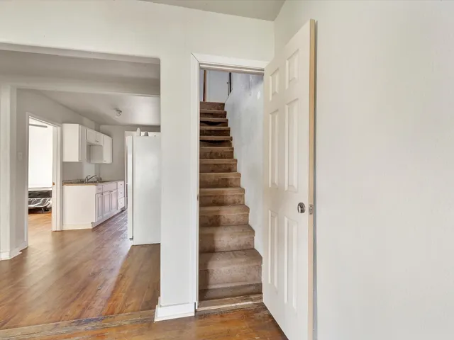 a view of a hallway view with wooden floor and staircase