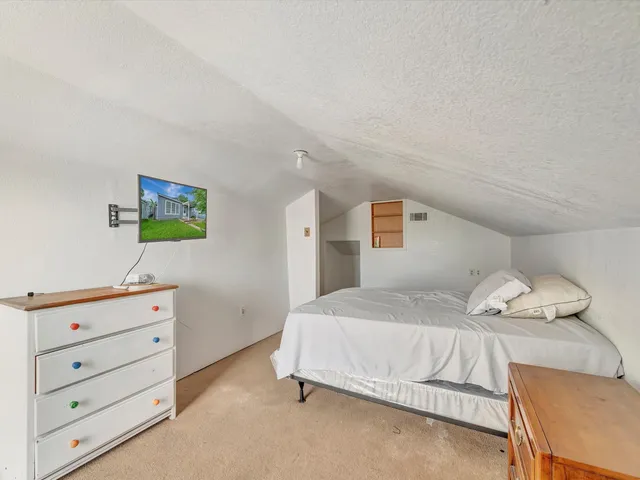 a bedroom with a bed and dresser