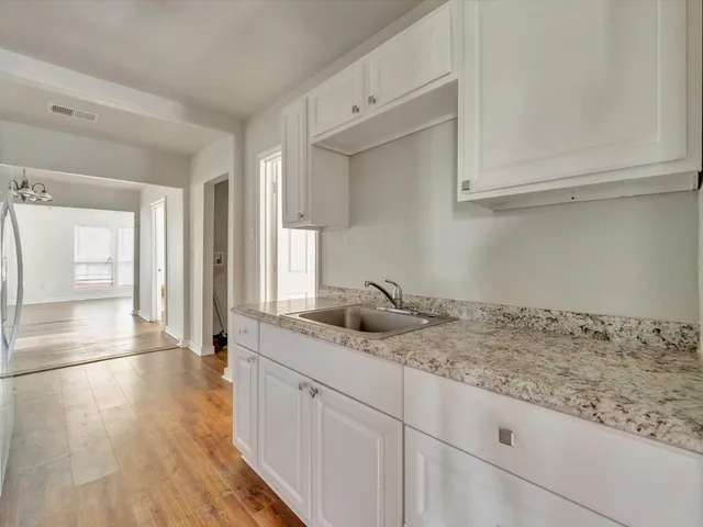 a kitchen with a sink and cabinets