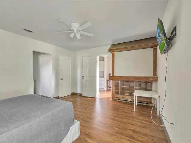 a bedroom with furniture and a wooden floor