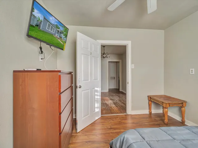 a view of a hallway with wooden floor and dining room
