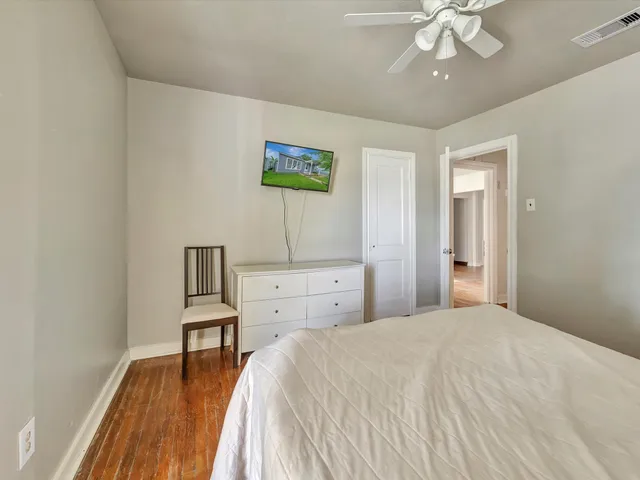 a spacious bedroom with a bed and a table in it