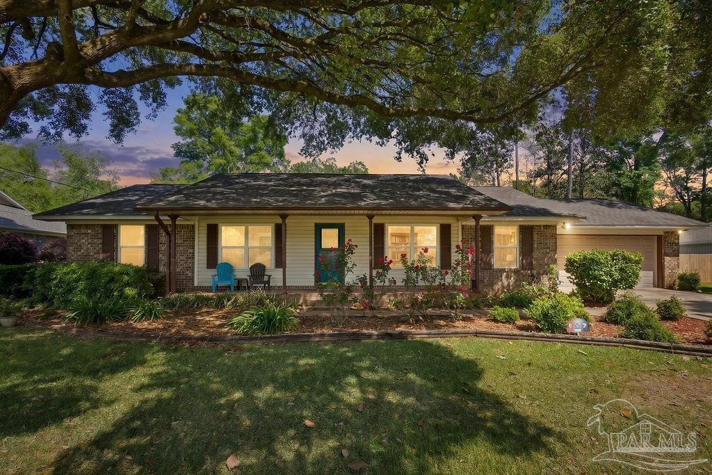 a front view of house with yard and outdoor seating