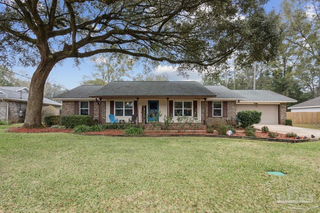 a front view of a house with a garden and porch