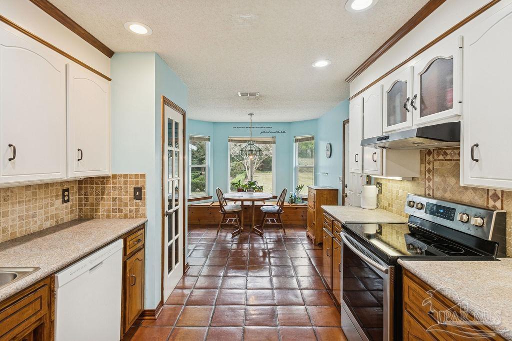 5132 Rowe Trail Pace, FL 32571 - Photo 11 of 26 a kitchen with stainless steel appliances granite countertop a stove top oven a sink dishwasher and cabinets with wooden floor