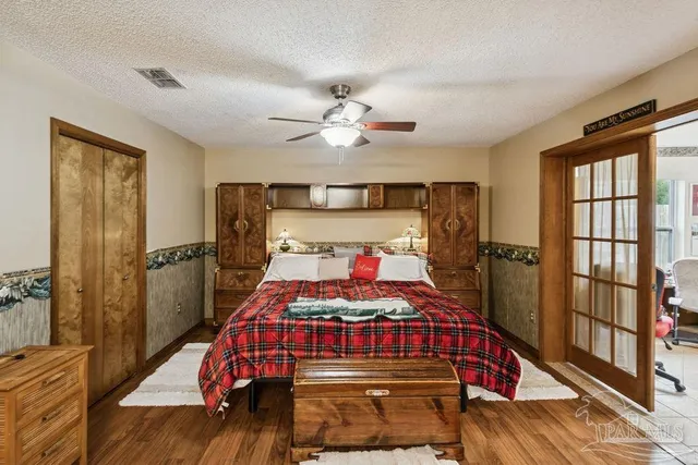 a bedroom with a bed and a chandelier