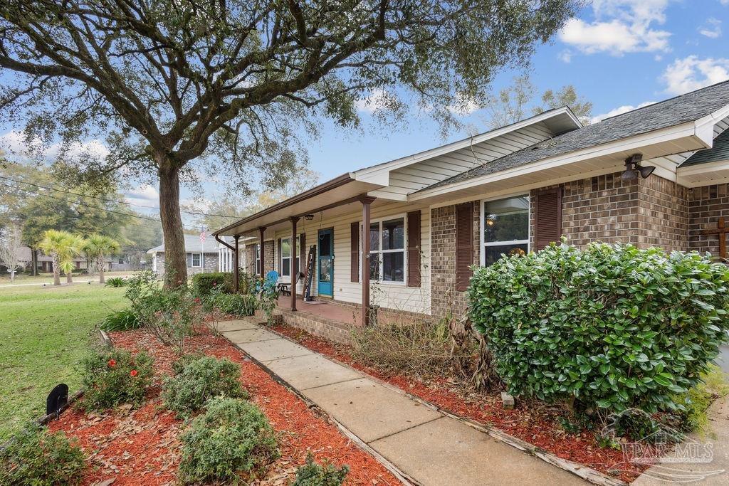 5132 Rowe Trail Pace, FL 32571 - Photo 4 of 26 a front view of a house with garden