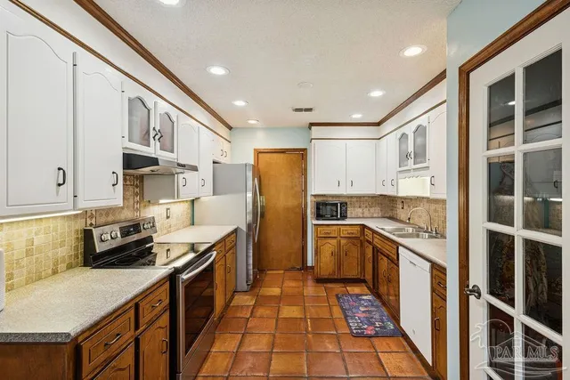 a kitchen with stainless steel appliances granite countertop a stove and a refrigerator