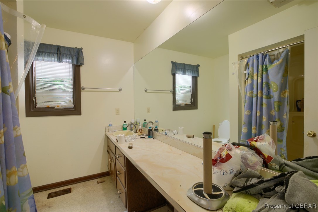 2488 Winfred Road Hayes, VA 23072 - Photo 20 of 25 Bathroom with vanity and a healthy amount of sunlight