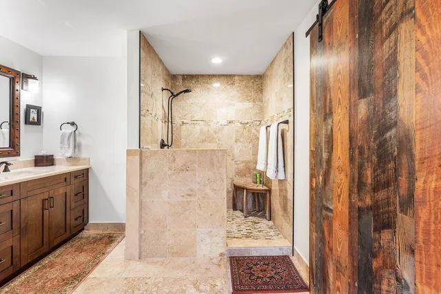 a bathroom with a sink a toilet and shower