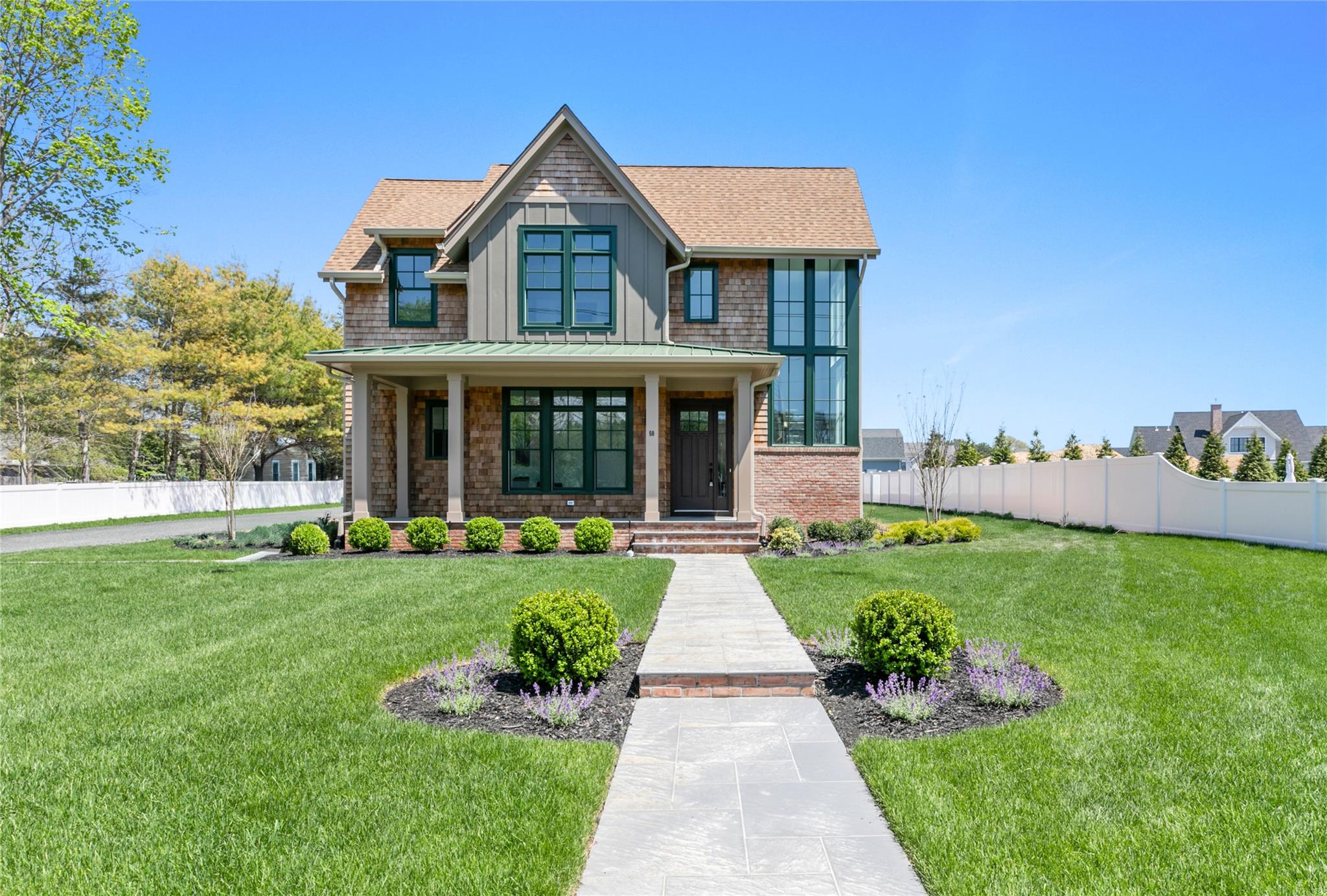 a front view of a house with a yard table and chairs