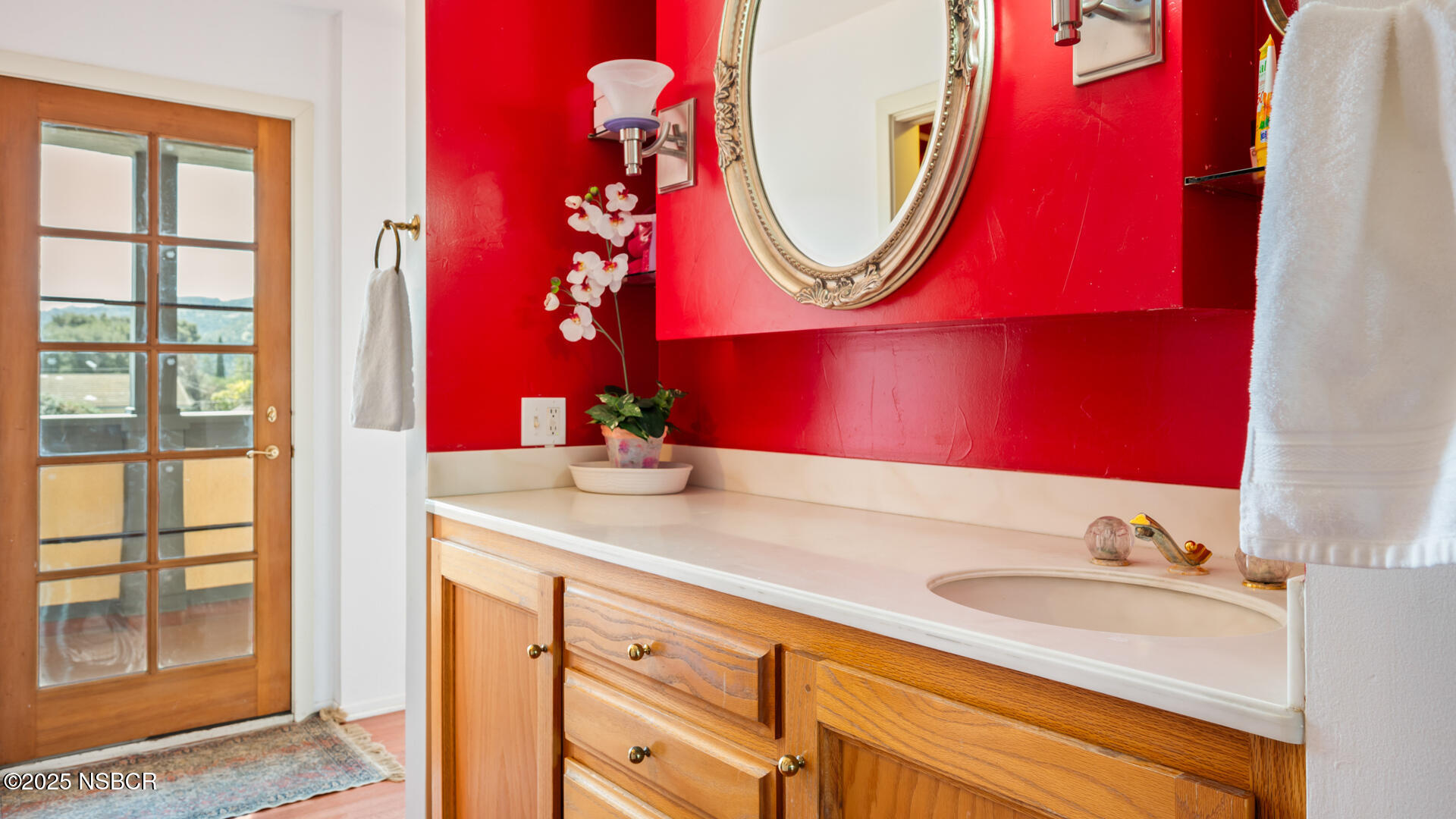 437 2nd Street Solvang, CA 93463 - Photo 14 of 39 a bathroom with a sink vanity mirror and a bathtub