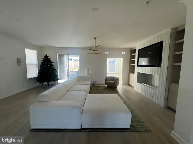 a large bedroom with a large bed a couch and a flat screen tv