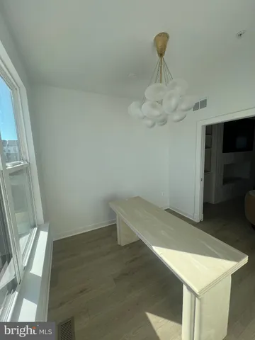 a view of a livingroom with wooden floor and closet