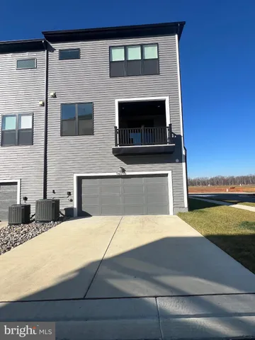a view of a kitchen with furniture and wooden floor