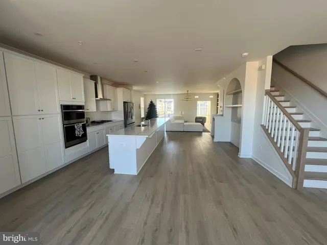 a view of kitchen with microwave and cabinets