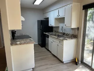 a view of a kitchen with wooden floor and a sink
