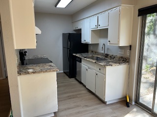 7711 Meadowview Lane, Unit B Austin, TX 78752 - Photo 3 of 7 a kitchen with a stove a sink and a refrigerator