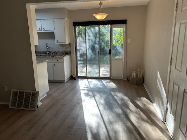 7711 Meadowview Lane, Unit B Austin, TX 78752 - Photo 4 of 7 a view of a kitchen with wooden floor and a sink