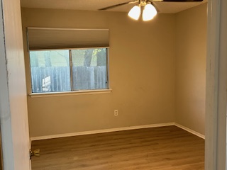 7711 Meadowview Lane, Unit B Austin, TX 78752 - Photo 6 of 7 a view of empty room with wooden floor and fan