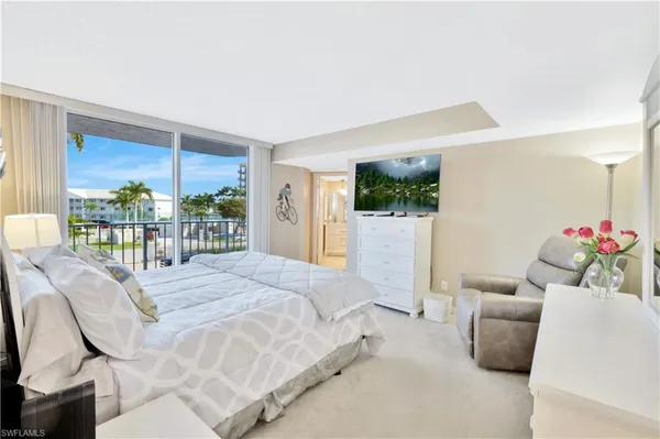 a bedroom with a balcony a bed and a couch