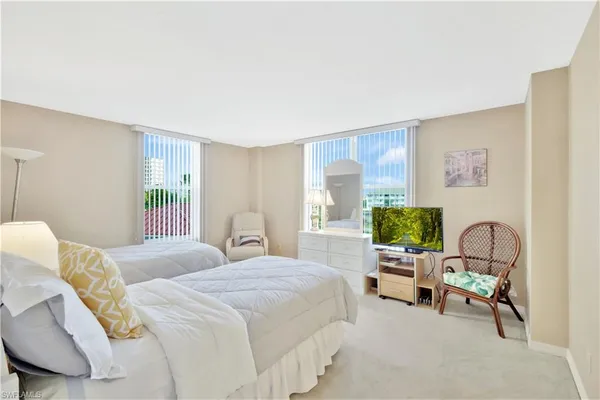 a bedroom with a bed chair and a window