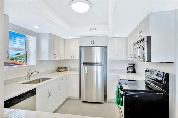 a kitchen with a sink appliances and cabinets