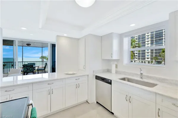 a kitchen with sink cabinets and window