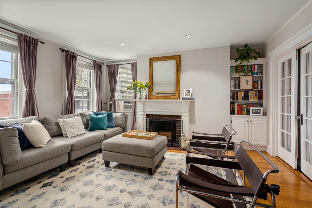 43 Linnaean Street, Unit 32 Cambridge, MA 02138 - Photo 3 of 20 a living room with furniture fireplace and a window
