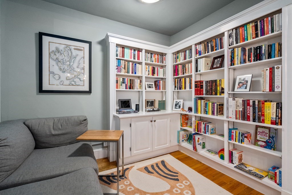 43 Linnaean Street, Unit 32 Cambridge, MA 02138 - Photo 4 of 20 a living room with furniture and a book shelf