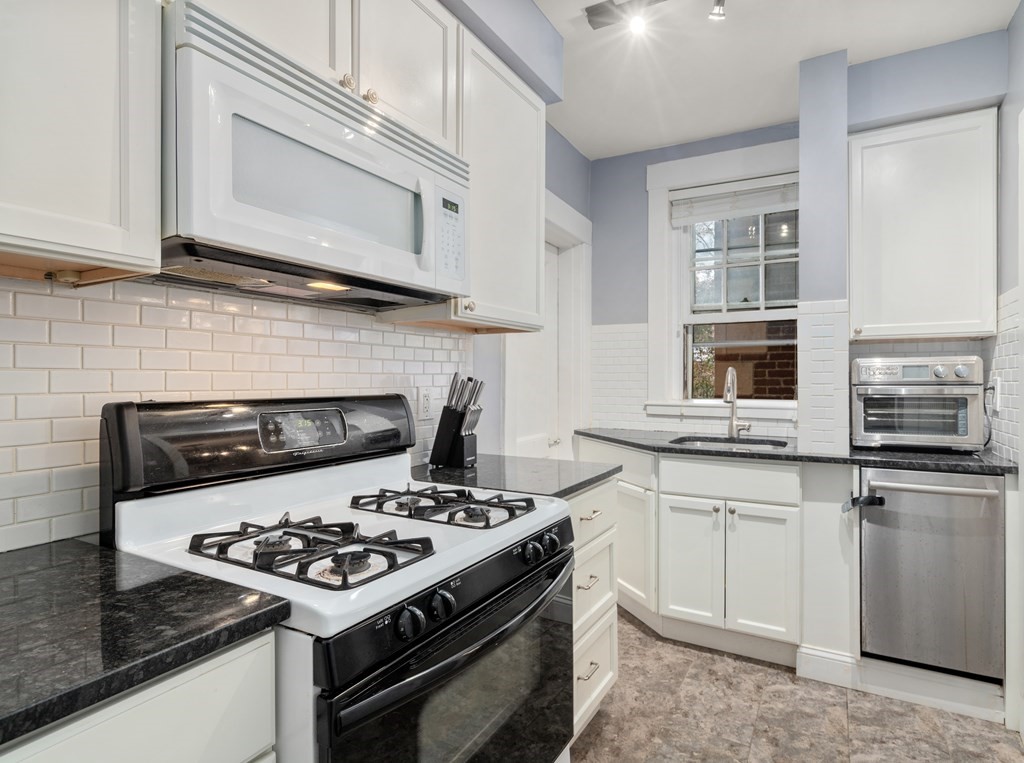 43 Linnaean Street, Unit 32 Cambridge, MA 02138 - Photo 7 of 20 a white stove top oven sitting inside of a kitchen