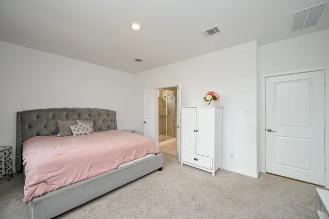 a bedroom with a bed and cabinets